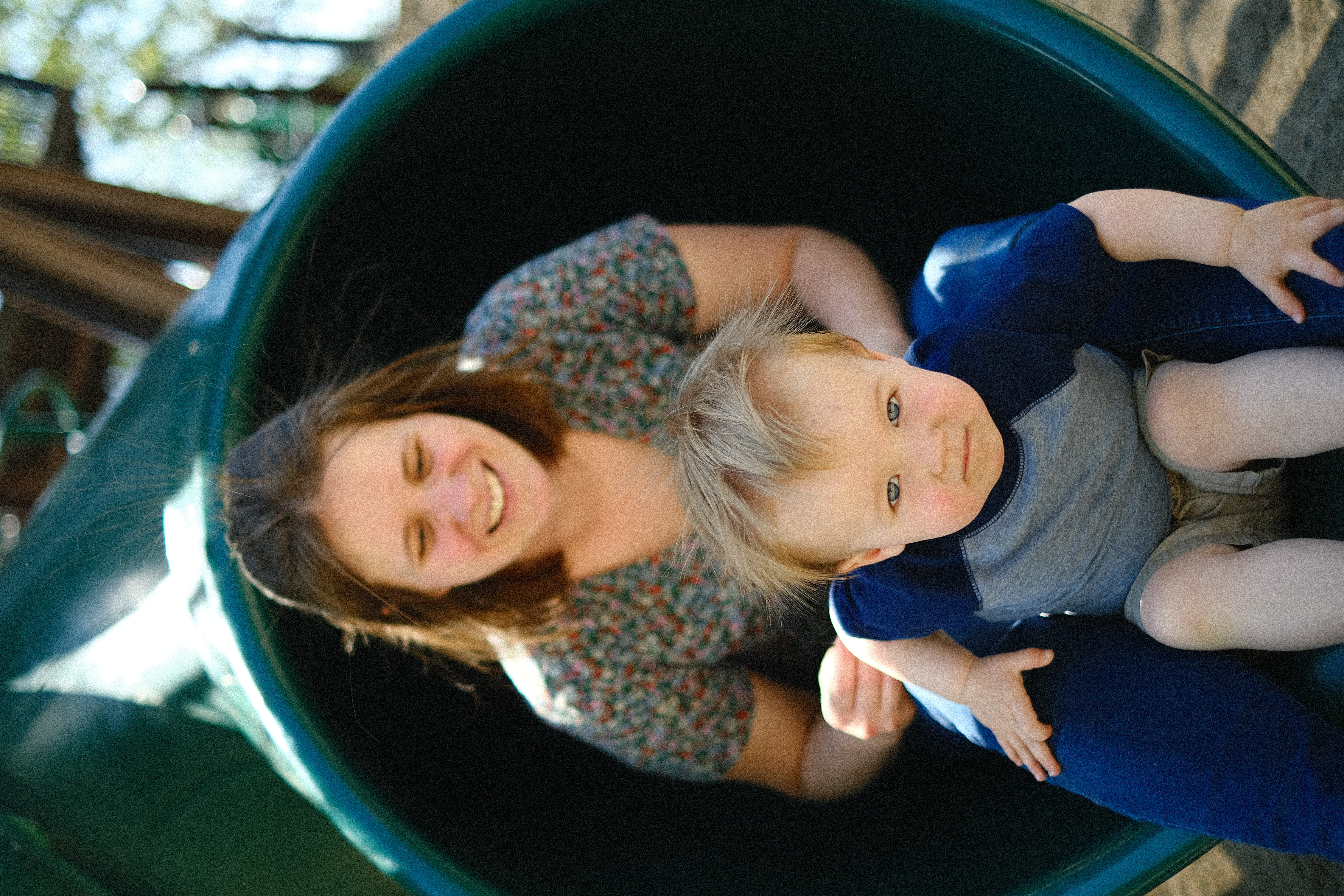 Parents reading to children in golden hour park light